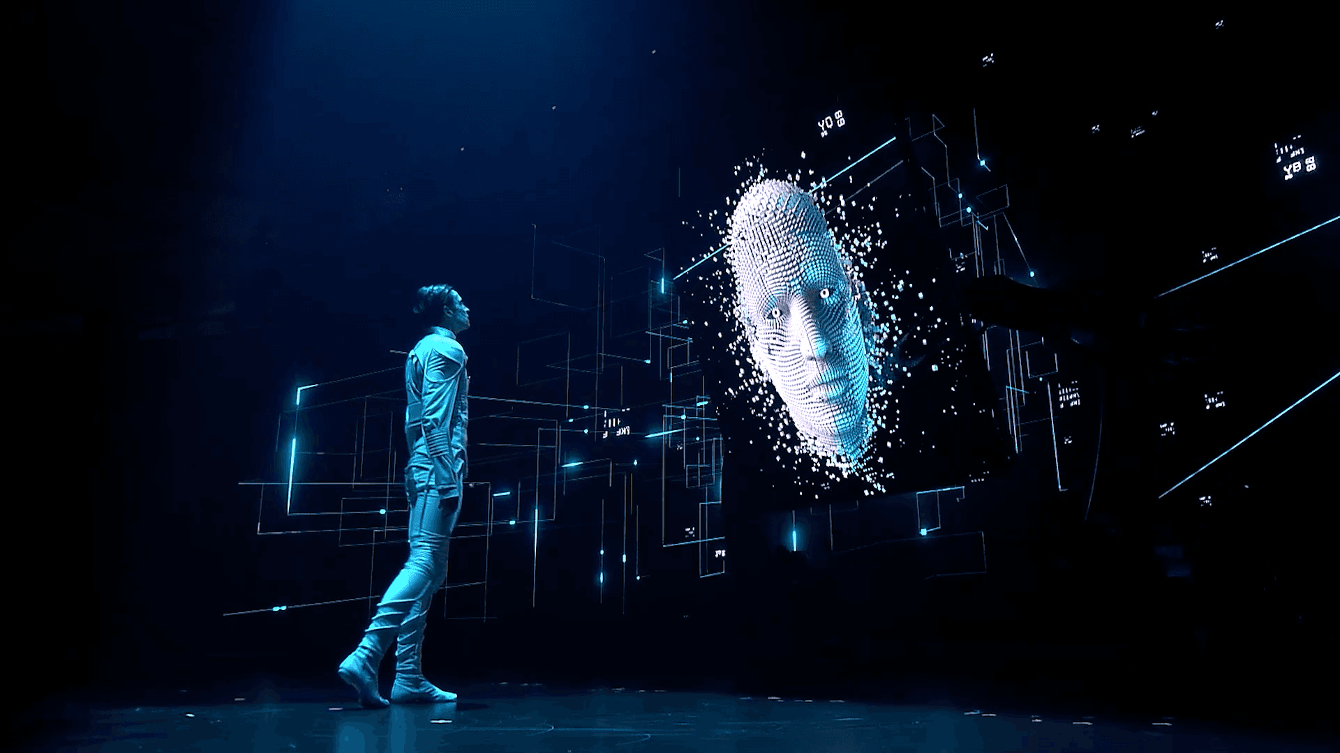 A performer interacts with LED screens during multimedia performance at the Global AI Summit 2022