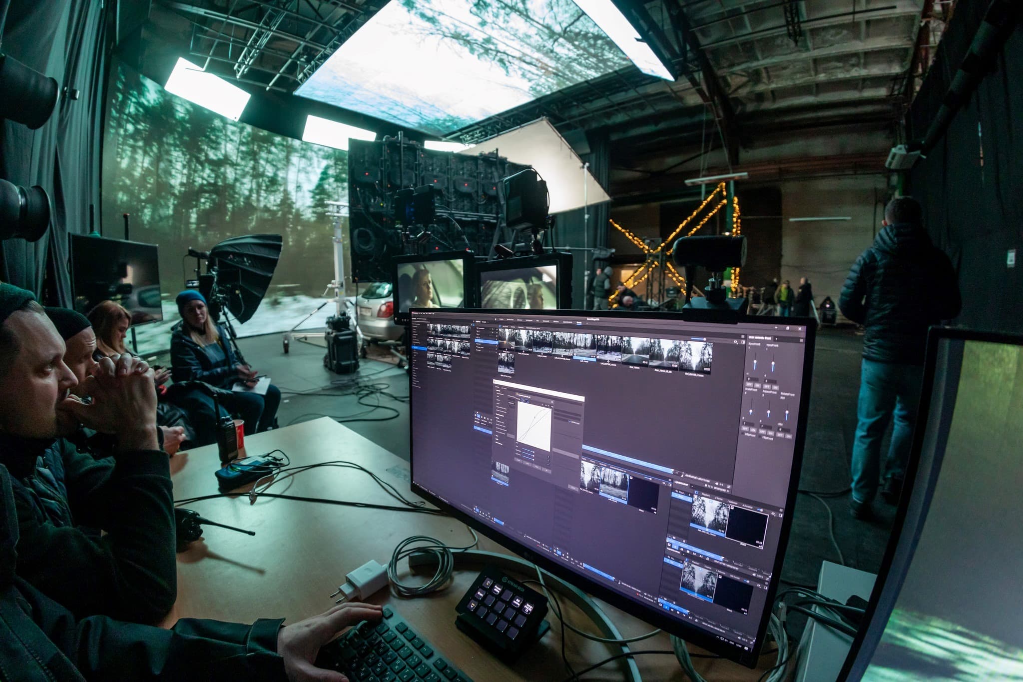 Screenberry media server interface against the backdrop of the virtual production set for filming car driving scenes