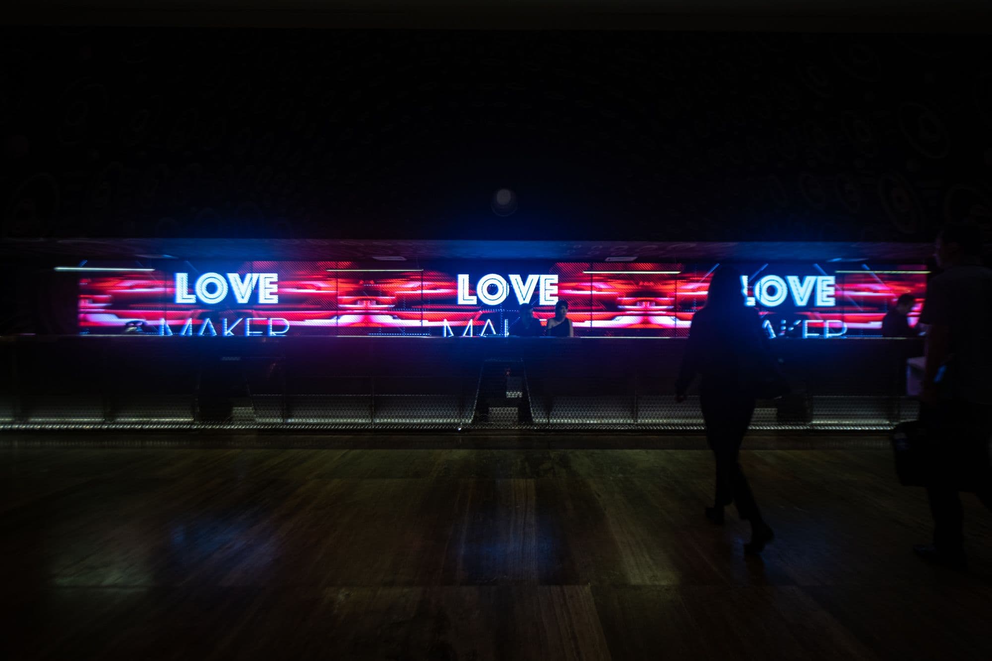 A video wall at the reception desk of the Melody Maker Cancun Hotel