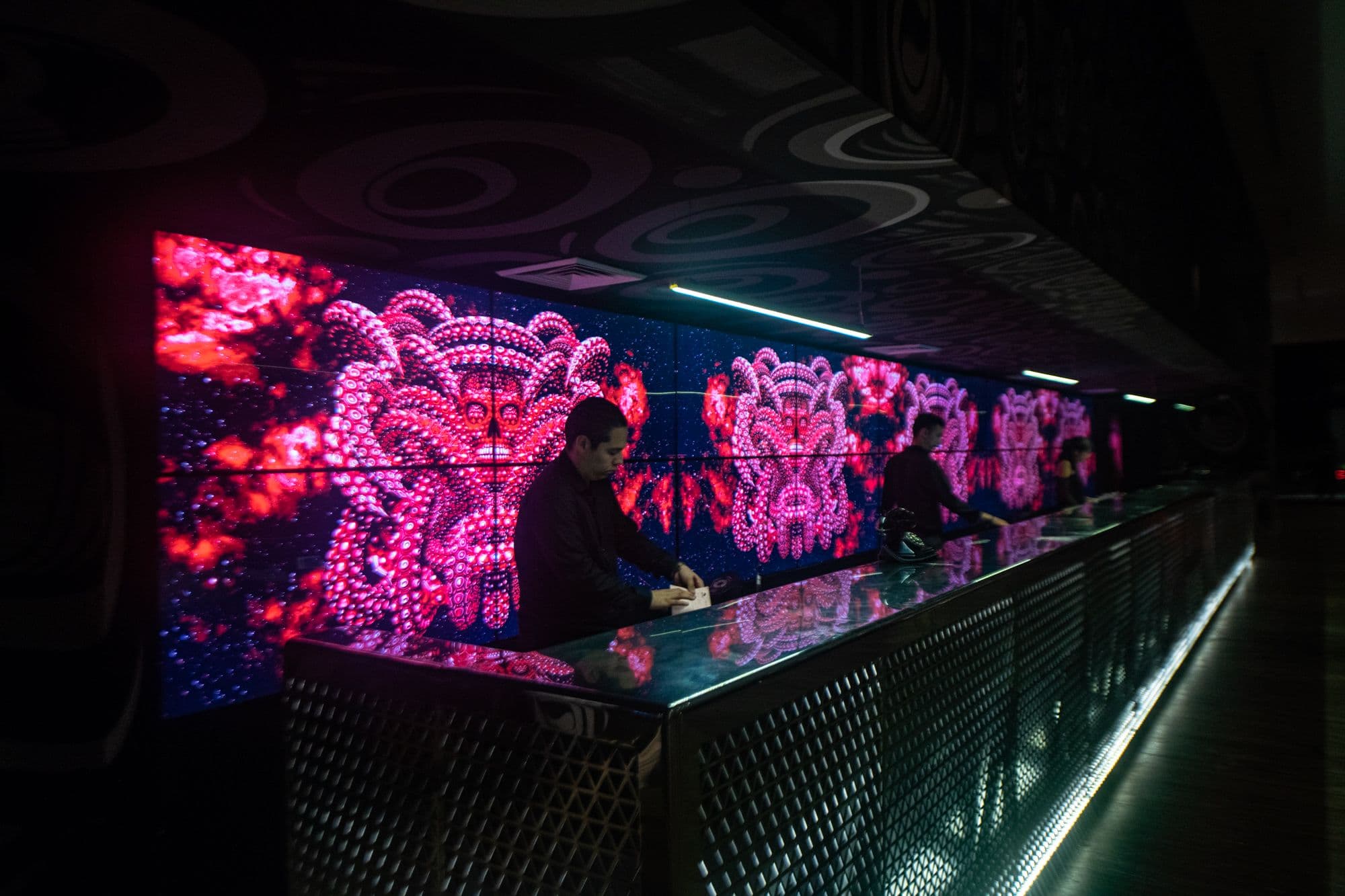 A video wall at the reception desk of the Melody Maker Cancun Hotel