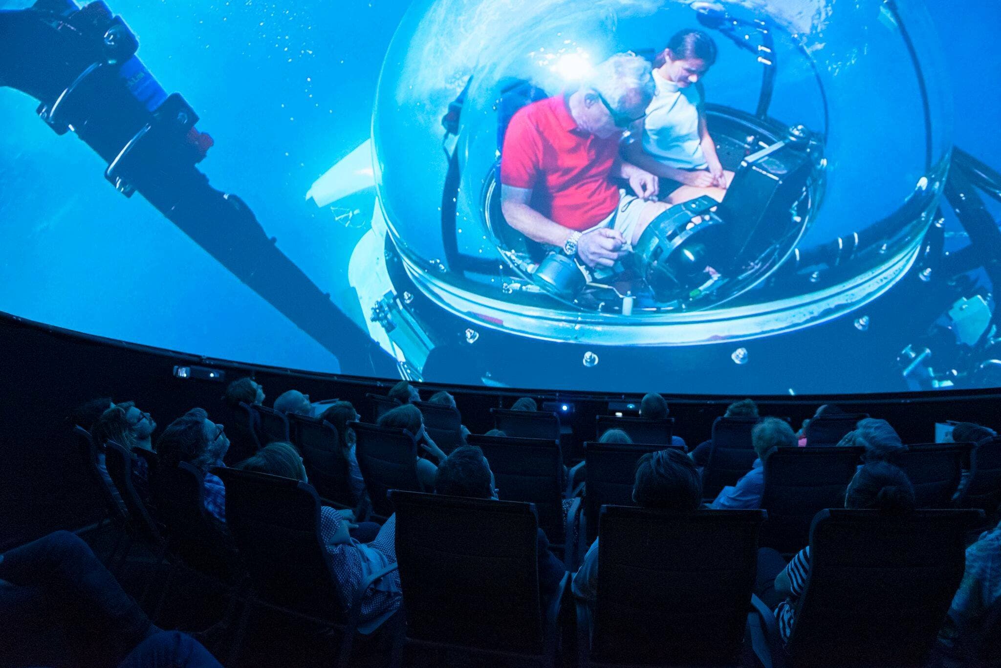 Audience watching Prospero Productions' underwater 360° movie in a touring dome theater, powered by Screenberry
