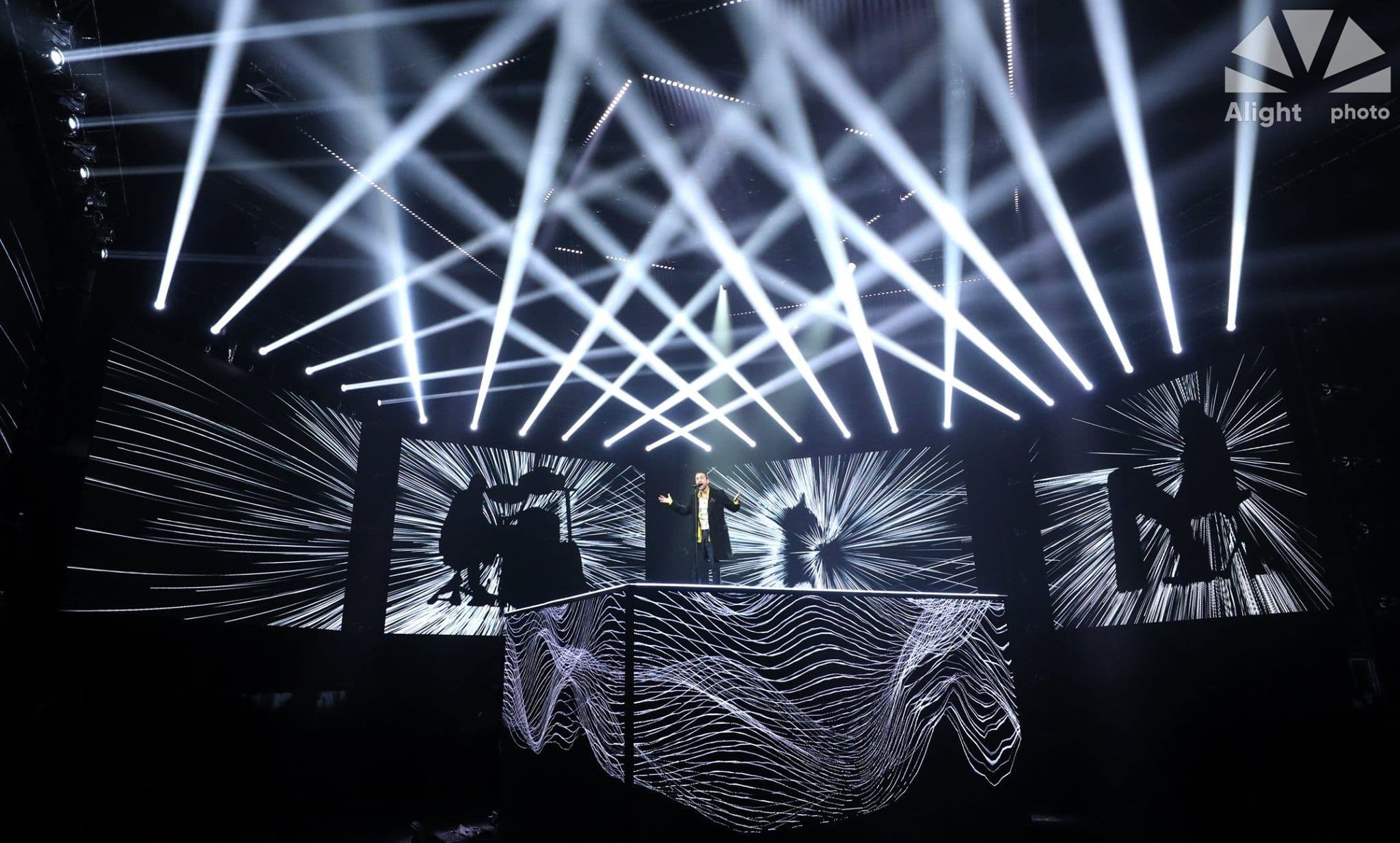 A singer performing on stage at the Voice Ukraine talent show super finale, surrounded by LED screens with the visuals controlled by Screenberry